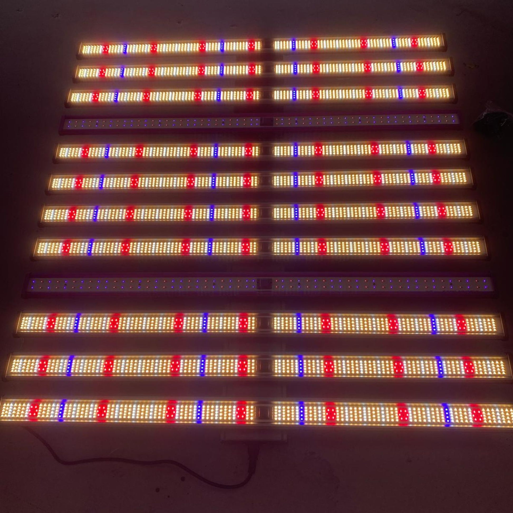 The 1060W Full Spectrum 12-Bar LED Grow Light – Pro Series illuminated, displaying its powerful array of white, deep red, far red, UV, and blue Samsung LM281B LEDs, optimized for all stages of plant growth in New Zealand